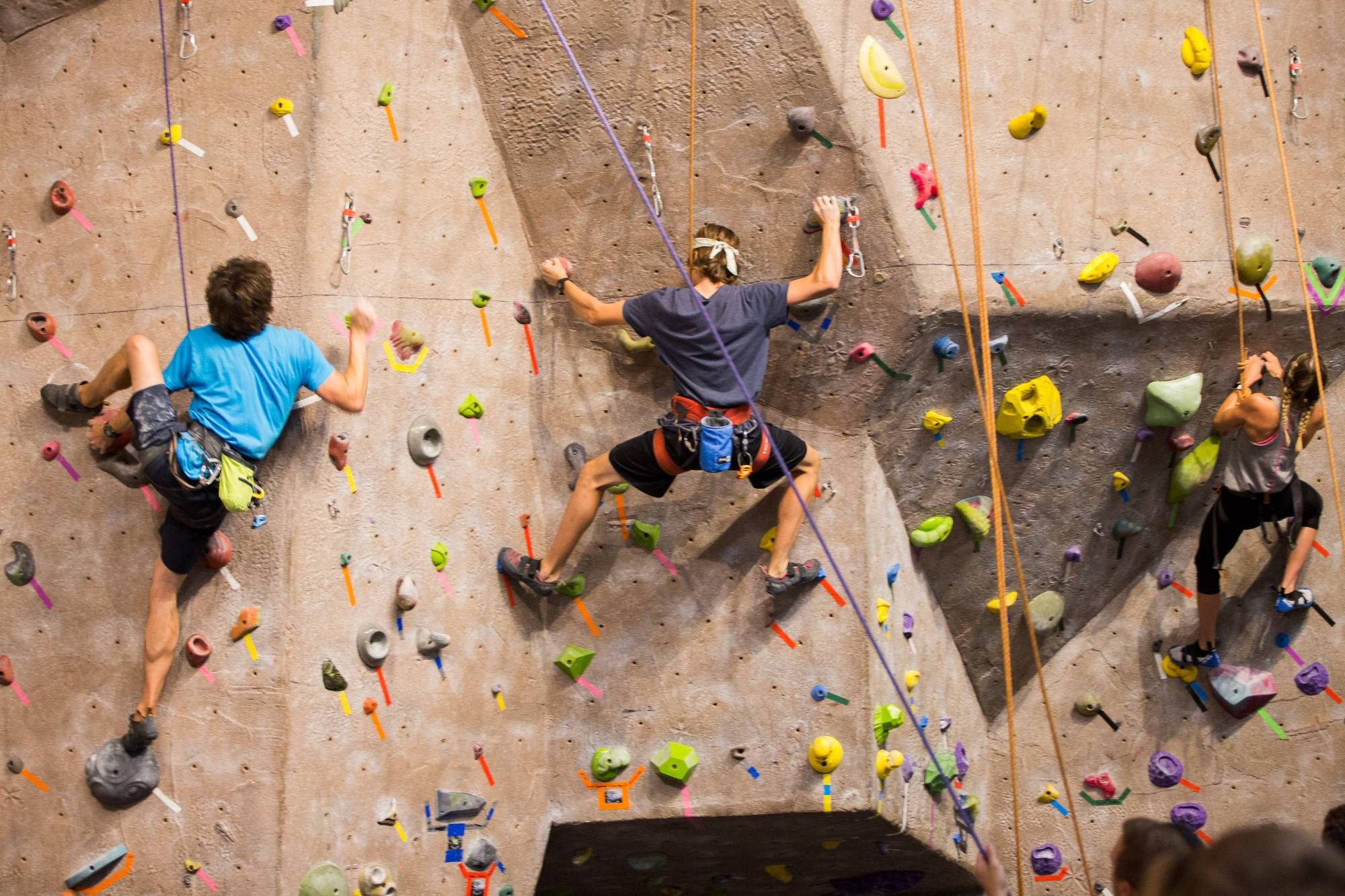 students climbing on the climbing center's rock wall